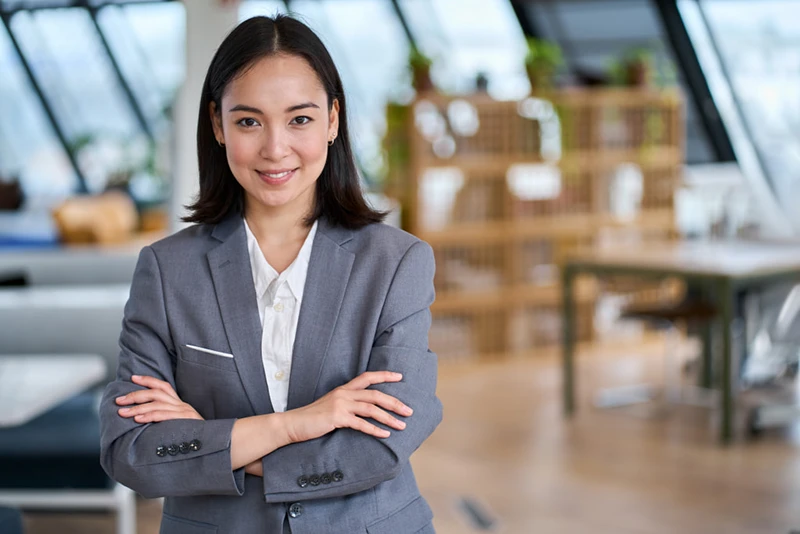 A wealthy woman who is a high income earner looks into the camera